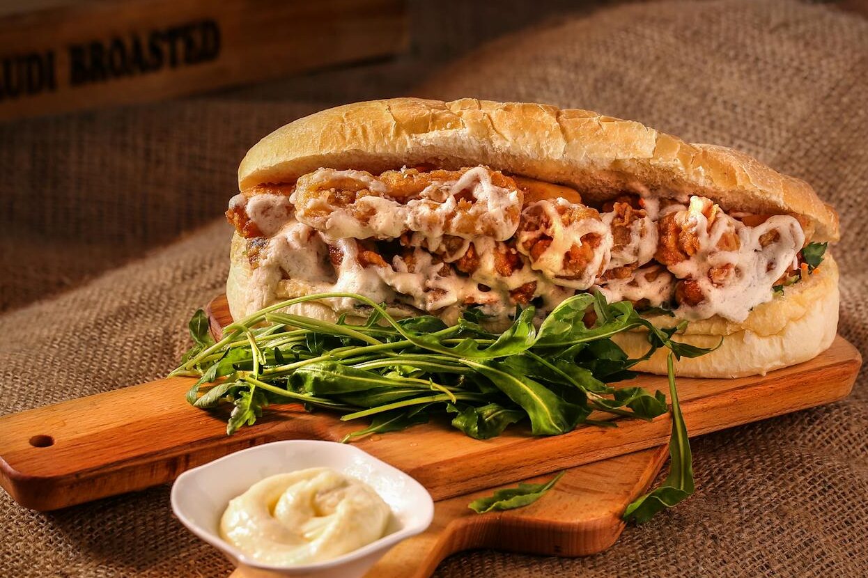 sandwich on wooden chopping board ordered takeout from Wicked Awesome